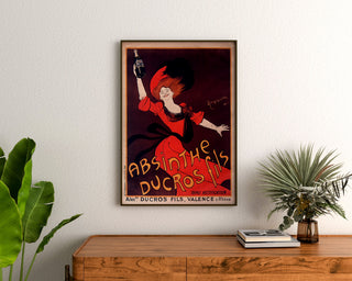 Vintage reklameplakat Absinthe Ducros, indrammet over en trækommode, mellem planter.