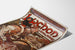 Vintage plakat Luchon, dronningen af Pyrænerne, vist på et let bøjet ark i perspektiv.