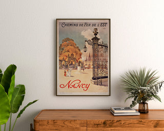 Vintage-plakat Nancy, chemins de fer de l’Est, indrammet over en trækommode mellem planter.